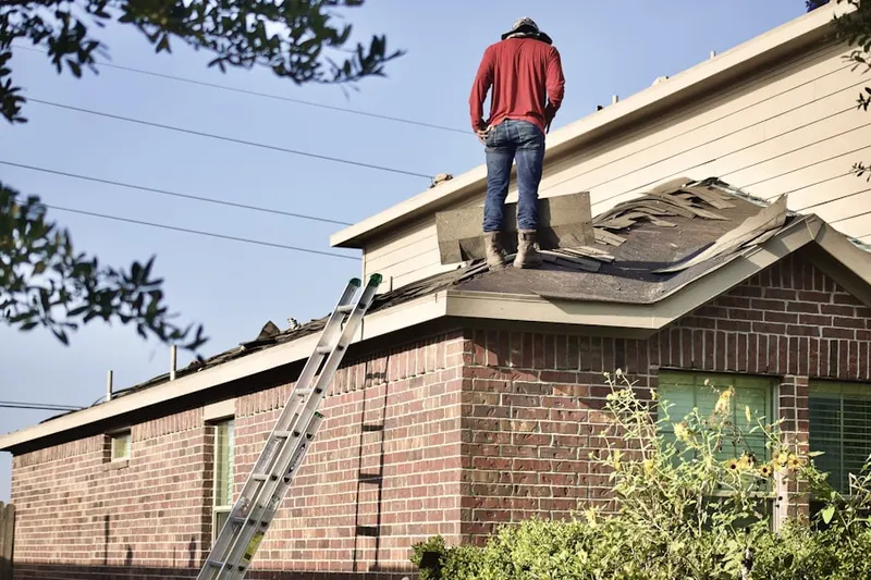 Professional roofer working on a residential roof in Chandlersville